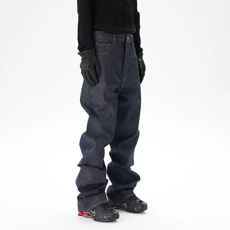 Man's dark blue loose-fit straight leg denim jeans on a neutral background.