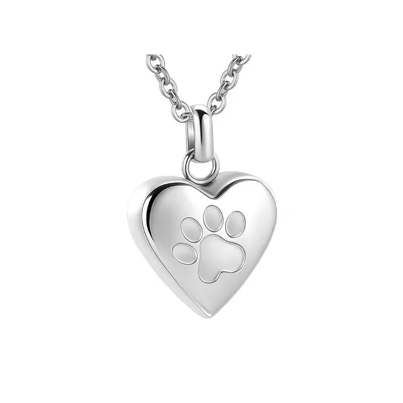 Silver heart pendant necklace with paw print design that opens as a casket.