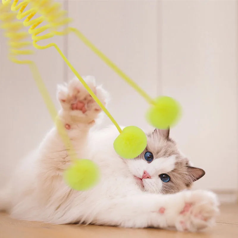 Blue cat toy with suction cup, spring rabbit fur ball, and retractable elastic rope on a door surface