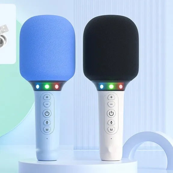 Pink Bluetooth children's handheld karaoke microphone with built-in speaker on white background