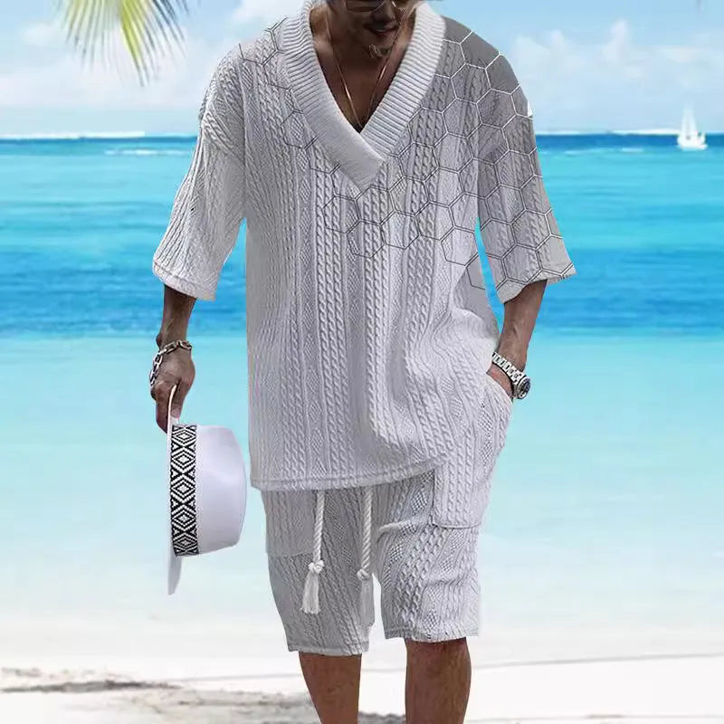 Man wearing a printed drop-shoulder knitted short-sleeve jacket with matching shorts in a casual setting.