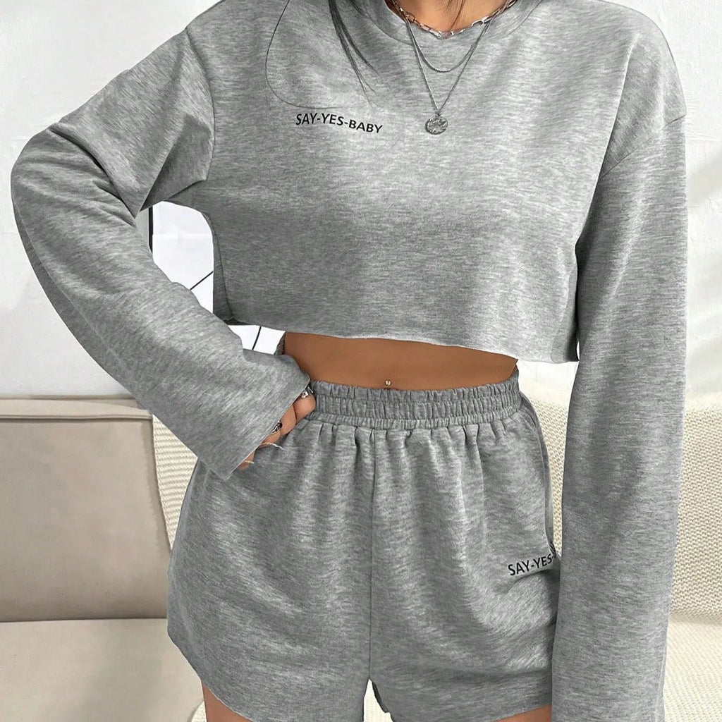 Grey women's long sleeve t-shirt and matching shorts loungewear set laid flat.