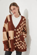 Loose fit knitwear cardigan with checks print in a selection of colours on a hanger.