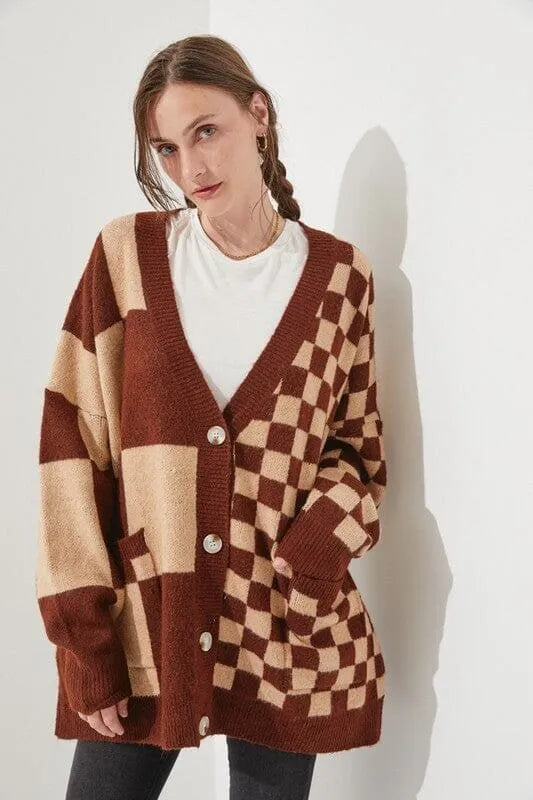 Loose fit knitwear cardigan with checks print in a selection of colours on a hanger.