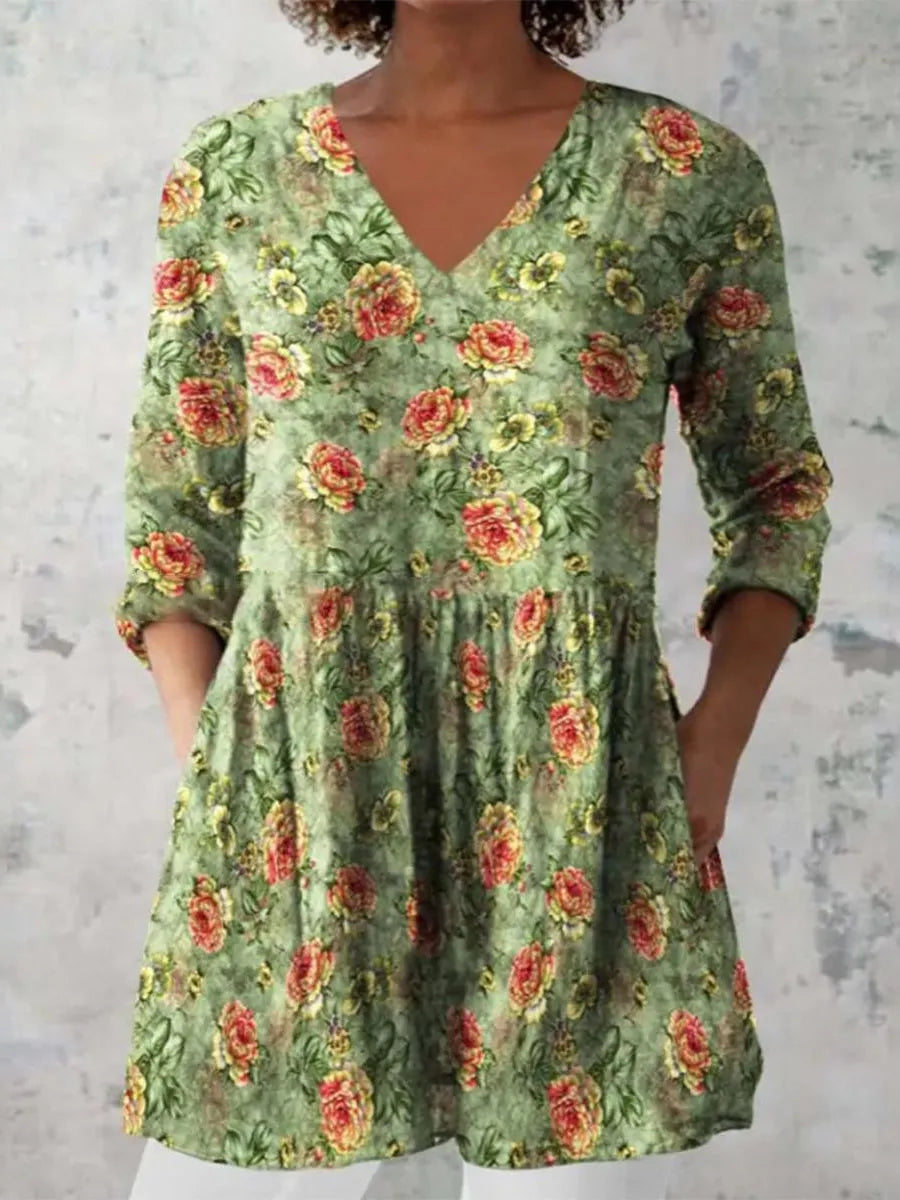 Women's floral wave print dress with wide waist and three-quarter length sleeves on a hanger.