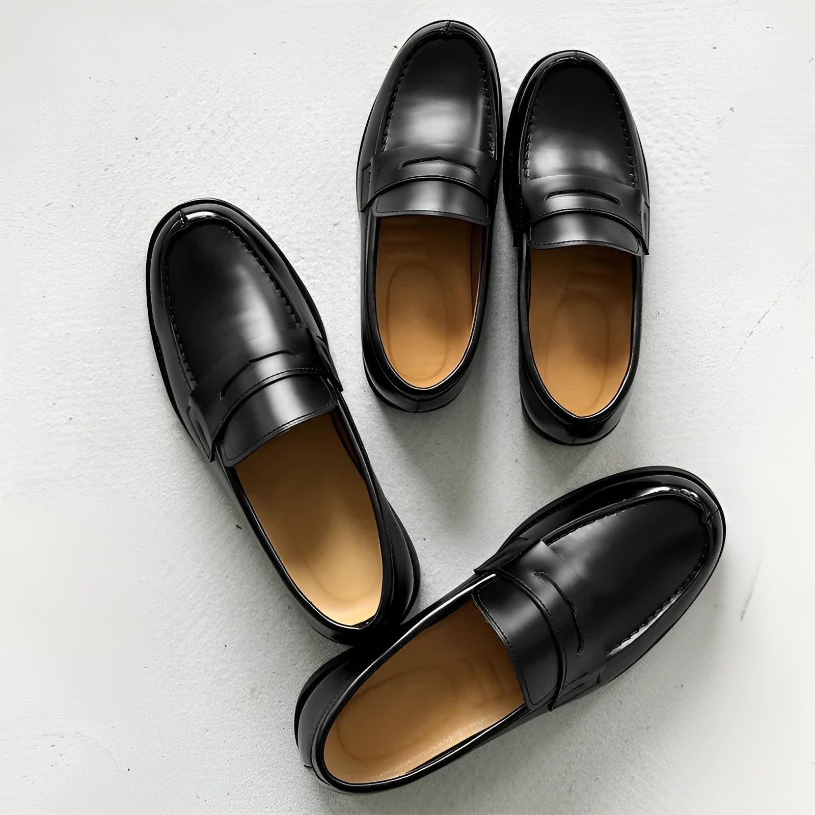 Black men's classic slip-on derby leather shoes with a rubber sole, shown in a mature style.