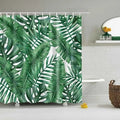 Tropical shower curtain with green foliage and white digital print on polyester, shown in a bathroom setting.