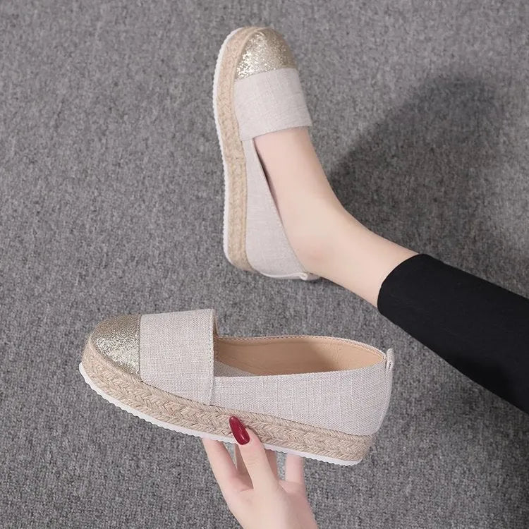 Women's plus size black canvas slip-on flat shoes with round toe, shown from the side.