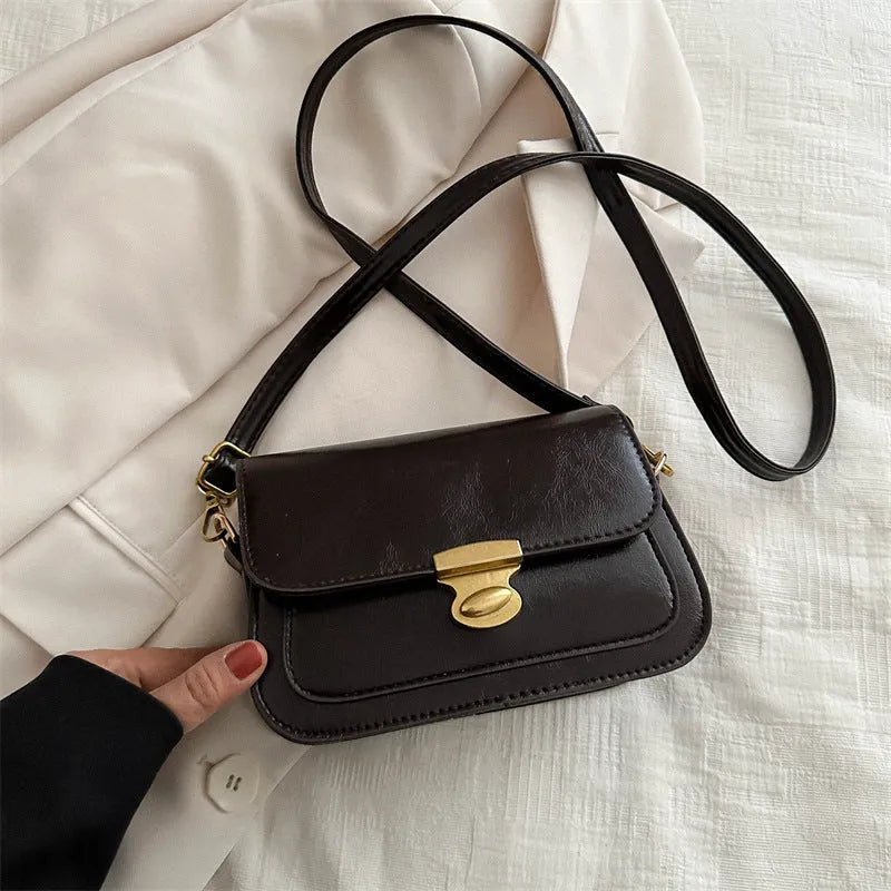 Small horizontal square handbag in soft PU leather, shown in black, brown, dark brown, and light brown.