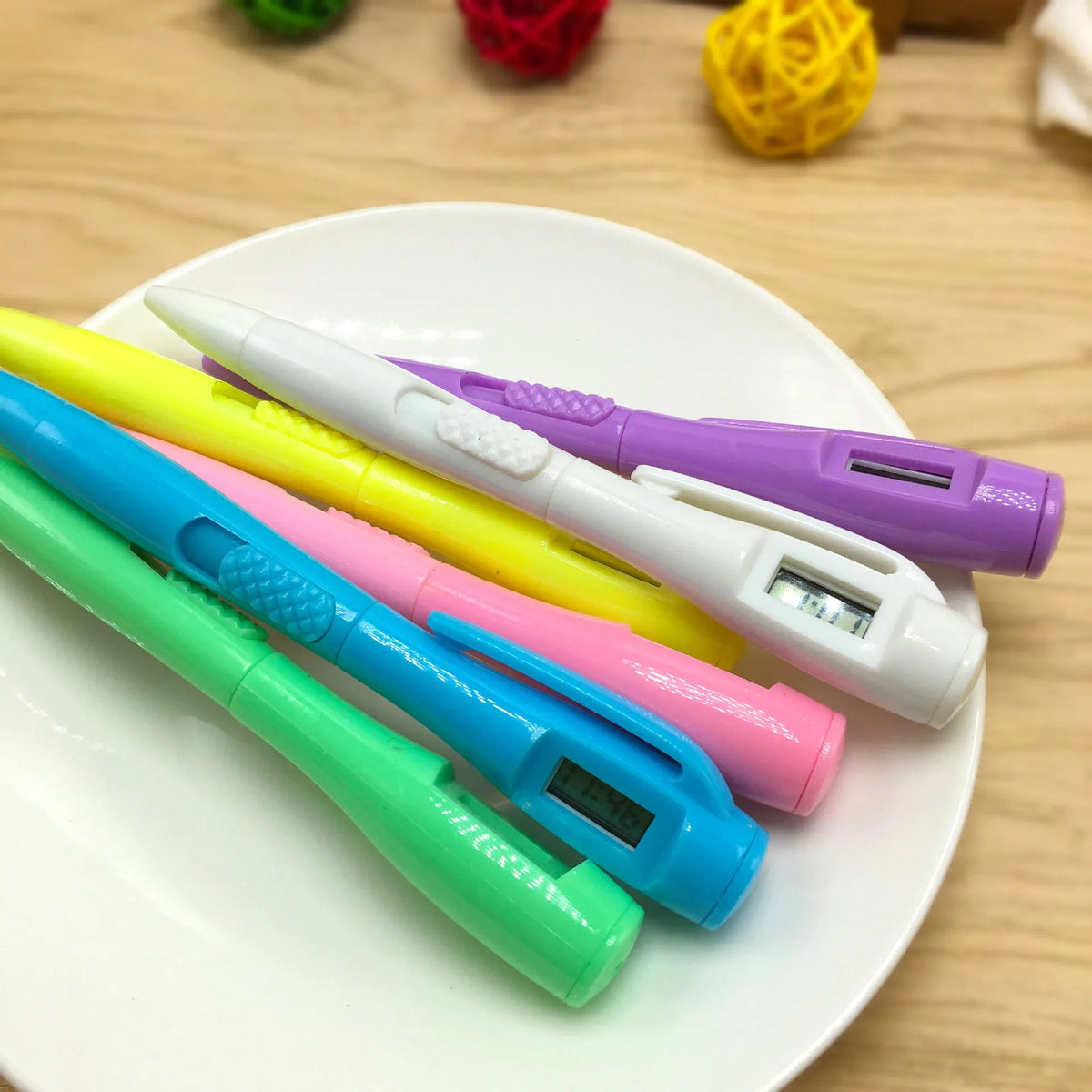 Electronic watch ballpoint pen with plastic shell and digital clock display, available in multiple pen head colours