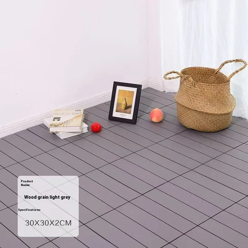 Ten wood grain plastic floor tiles stacked, showing dark grey and light grey colour options with non-slip texture.