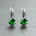 A pair of copper diamond-shaped earrings with inlaid zircon stones, shown in blue, green, and colour variants.