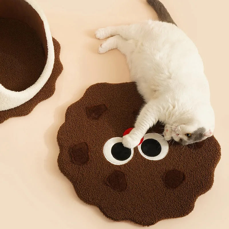 Khaki coloured enclosed cat nest shaped like a sandwich cookie for cold weather sleeping.