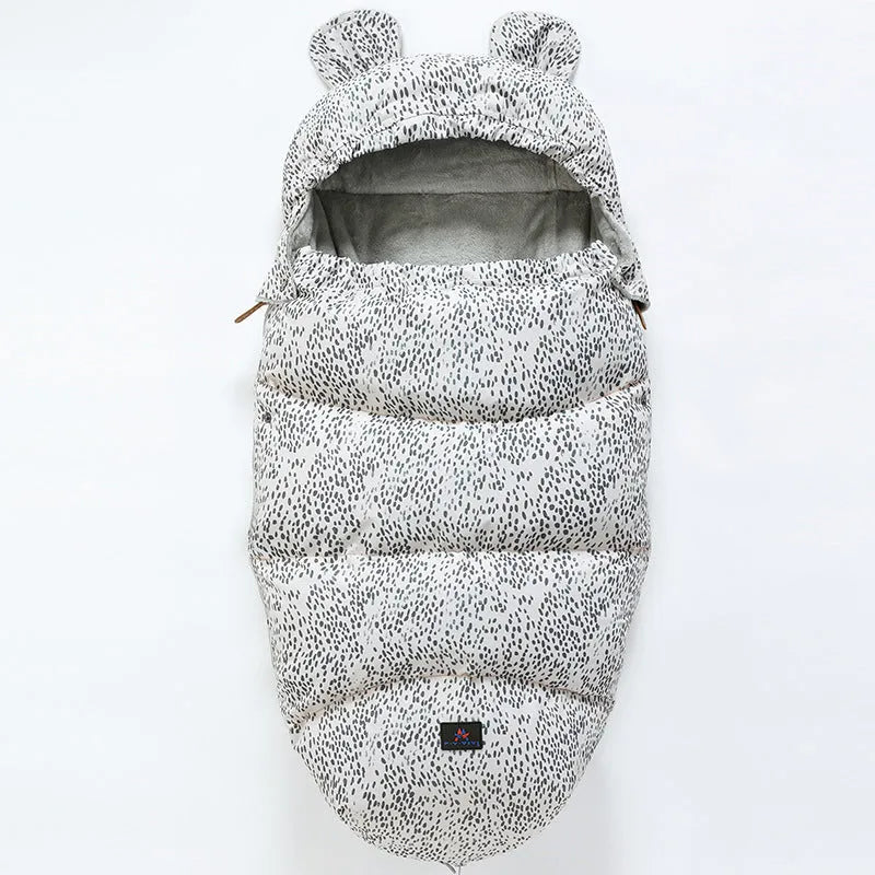 Convertible baby sleeping bag cocoon in a pram, showing cotton blend fabric and flannel lining.