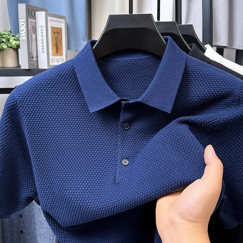 Man wearing a loose grey cotton short sleeve pullover sweater in a casual setting