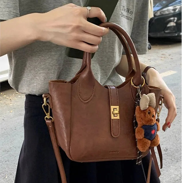 Women's Korean style small PU tote bag in bucket shape with sandwich pocket, apricot colour, simple design with sewing thread details