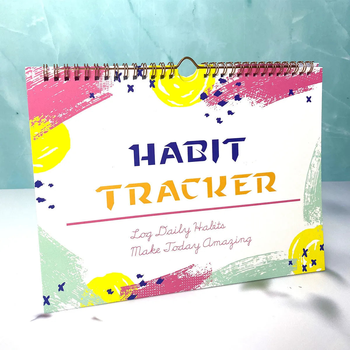 Habit tracking journal in four colour options showing 21cm × 28cm size