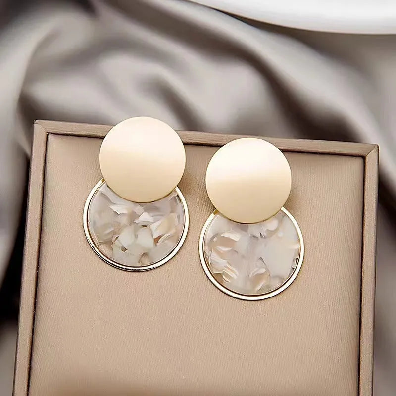 Round matte resin female earrings with retro design and smooth surface for casual wear.