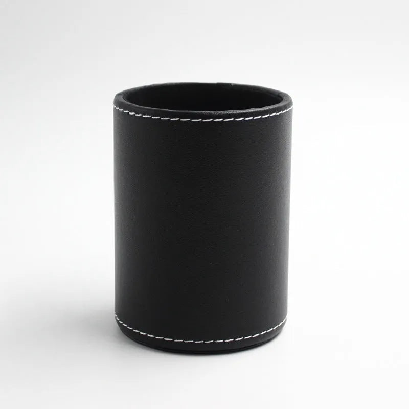 Black leather round pen container on desk with dimensions 8.0cm diameter 10.8cm height