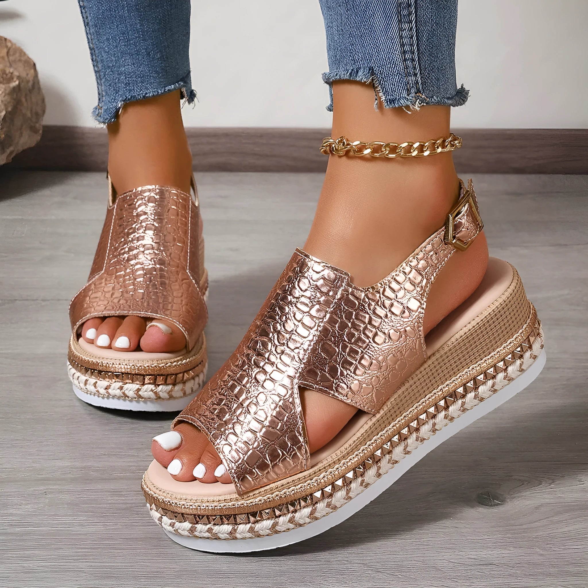 Gold Roman sandals with round toe, hollow-out design, and ankle buckle on rubber sole