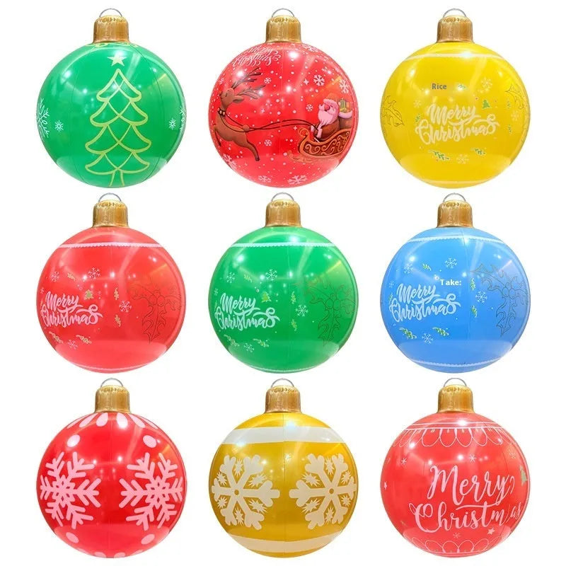 Large red inflatable Christmas ball with flashing lights displayed on a winter garden lawn.