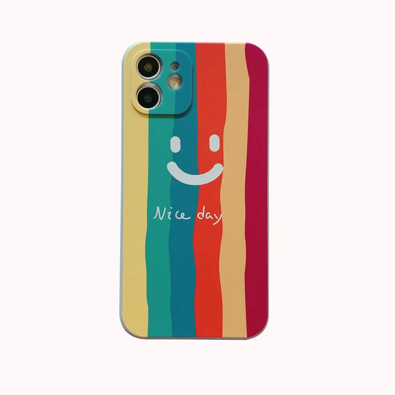 Simple TPU silicone iPhone case with painted smiley face and graffiti design on a table
