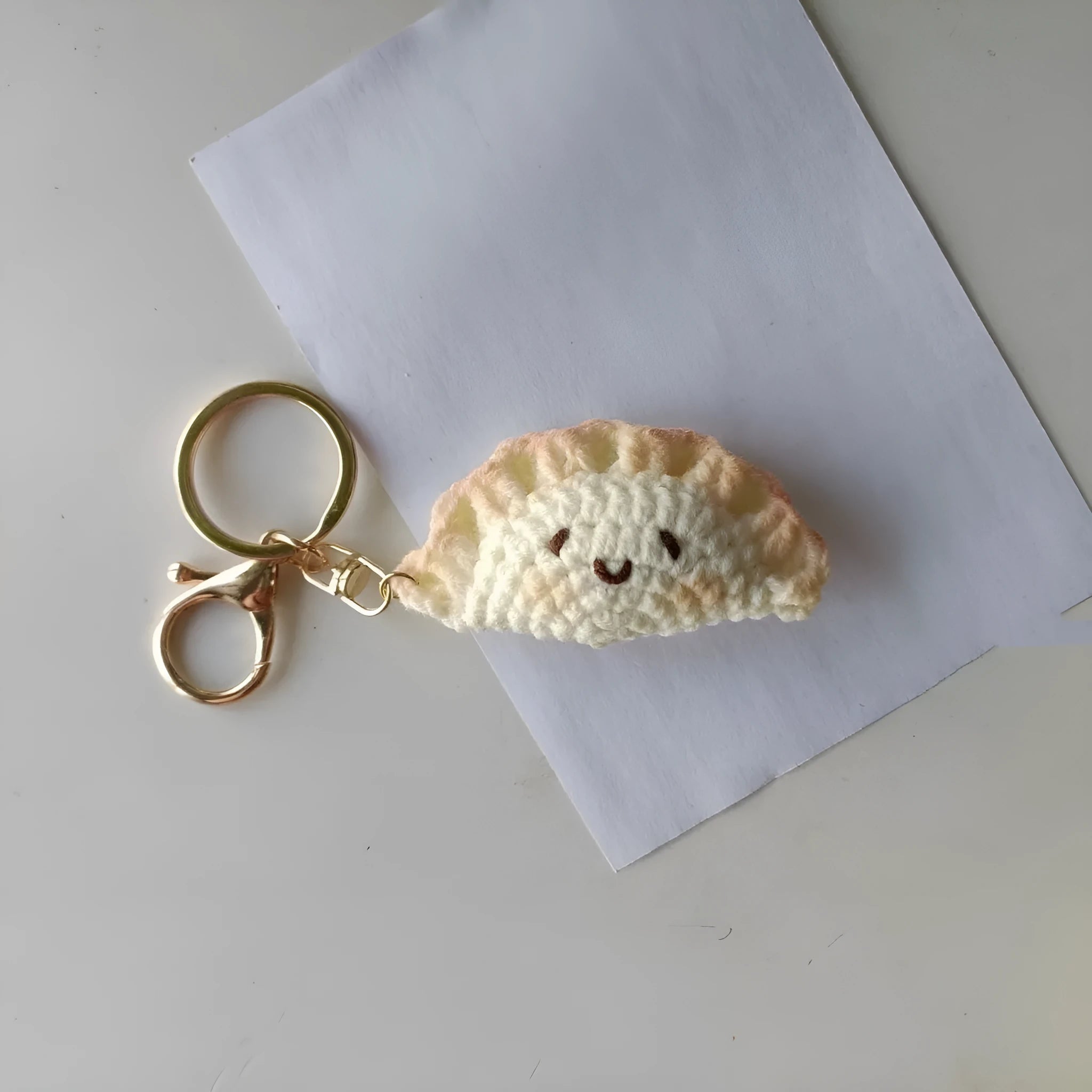Handmade crochet dumpling pendant with plush texture and keychain in traditional festival design