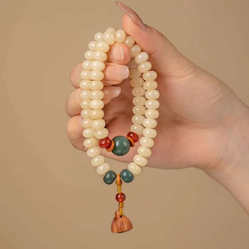Milk butter coloured Bodhi root wood bracelet with 6x9mm flat round beads on wrist