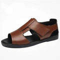Men's black and brown leather open-toe Roman sandals with a rubber sole on a plain background.
