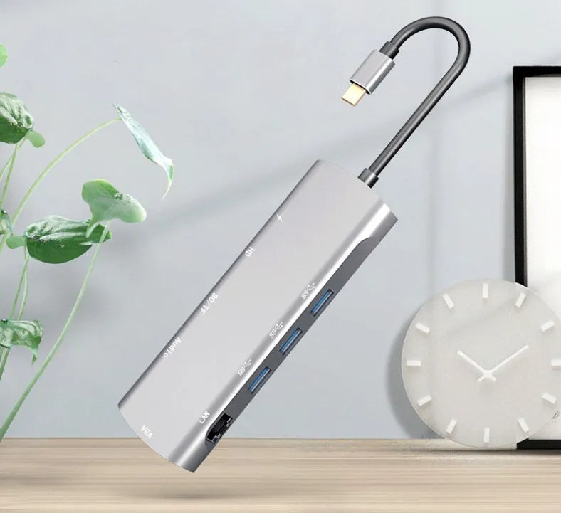Grey aluminium USB C docking station with HDMI, VGA, and USB ports.