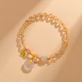 Gold rutilated quartz crystal bracelet with safety buckle and geometric pendant in national style design