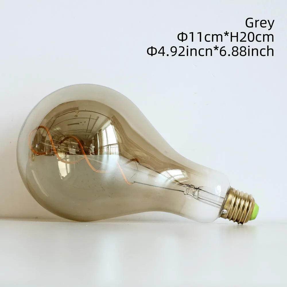 Double helix LED filament bulb in gold finish with spiral design visible through glass housing