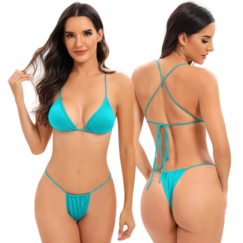 Women's striped one-piece swimsuit with cross-strap back, shown in a candy colour.