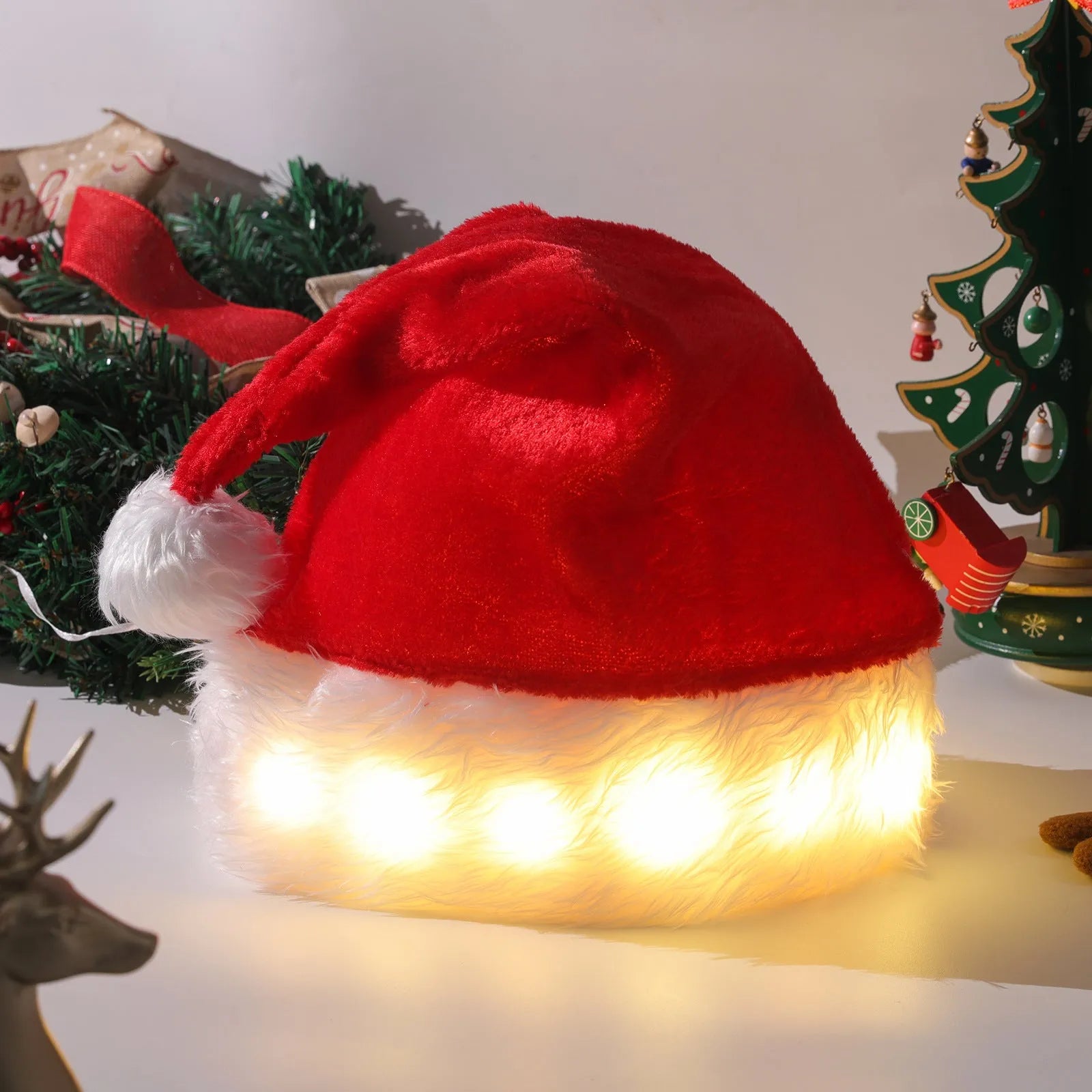 Red and white LED light up Santa hat with pom-pom, showing multicoloured twinkling lights on soft spandex material.
