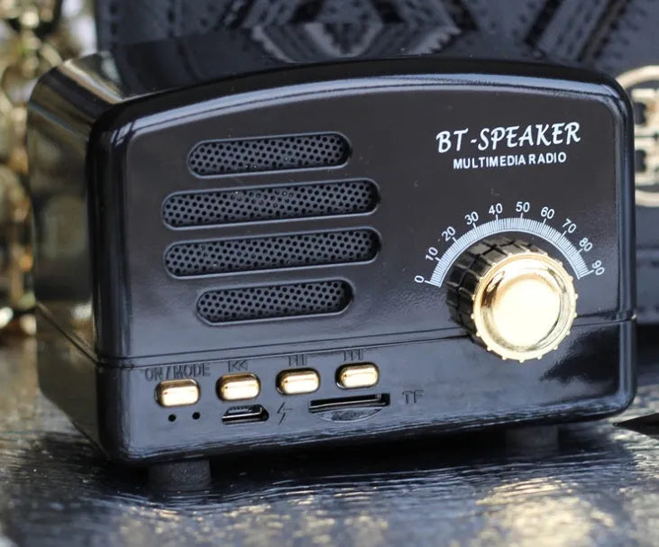 Compact vintage-style Bluetooth speaker in wood grain finish showing front grille and compact dimensions.