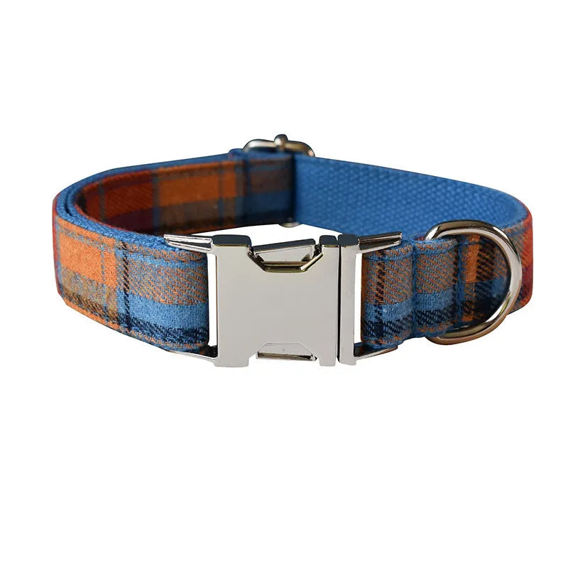 Blue background velvet plaid dog collar with a silver alloy buckle on a size tag.