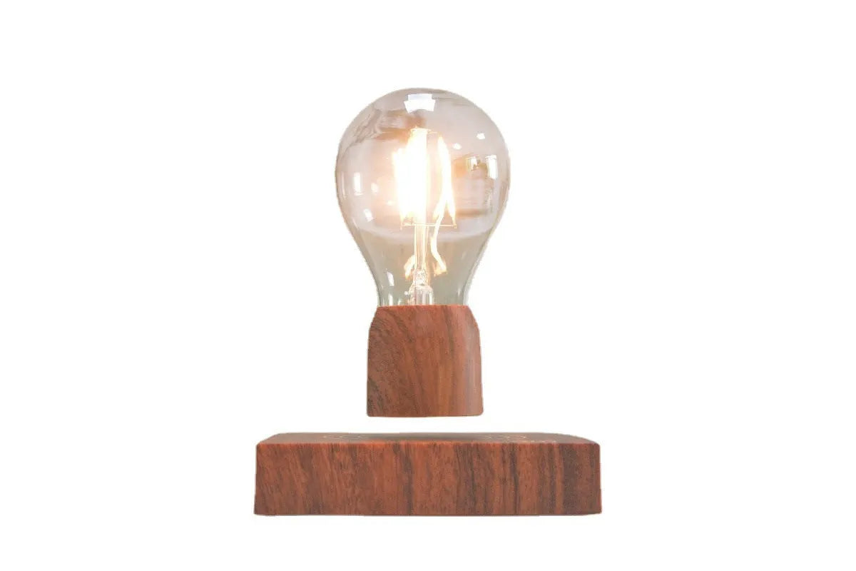 Magnetic levitation light bulb floating above its imitation wood base.