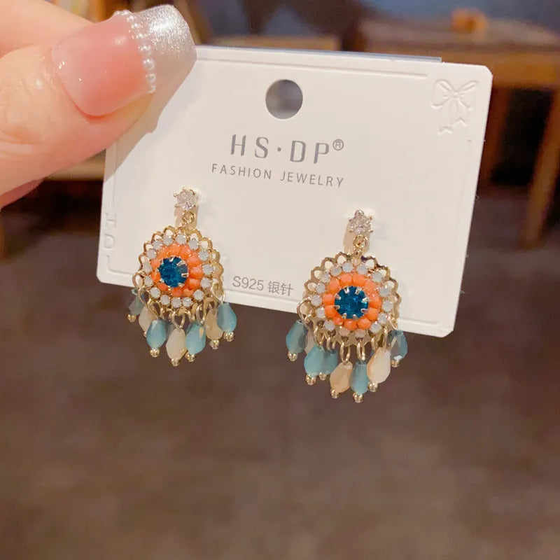 Geometric crystal tassel earrings with thick gold plating and embedded diamond crystals