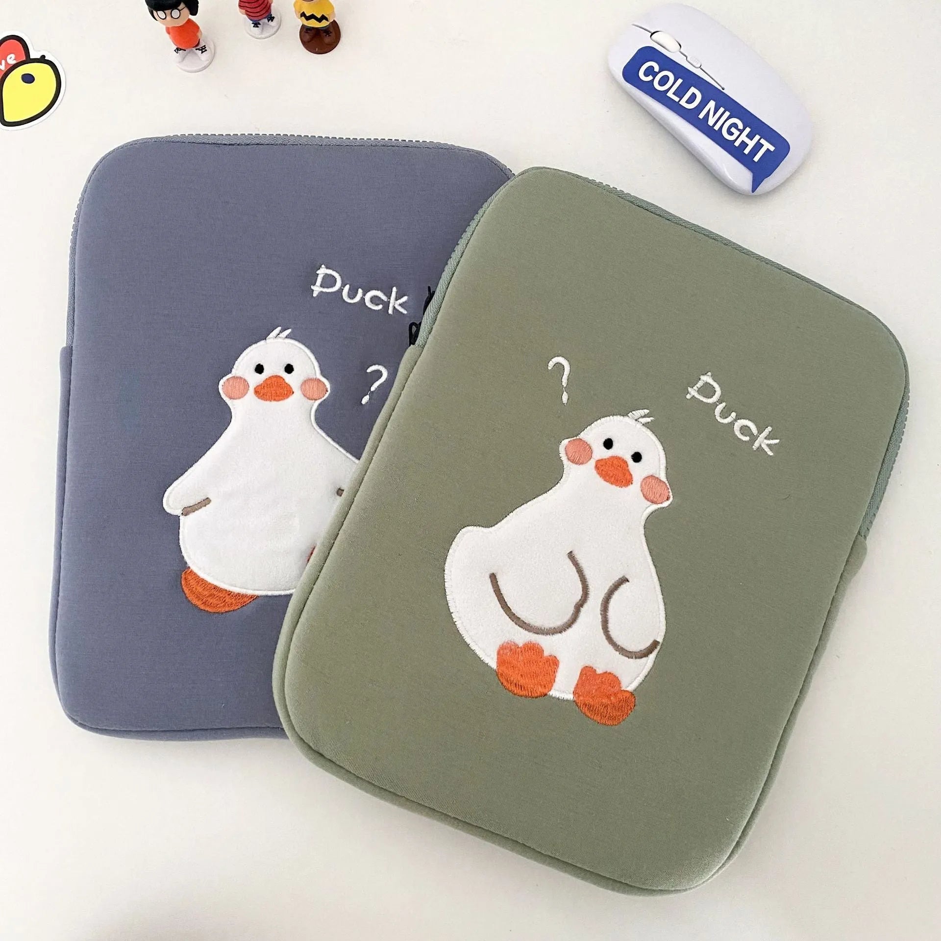 Blue cotton tablet case with cartoon duck embroidery and a zipper closure.