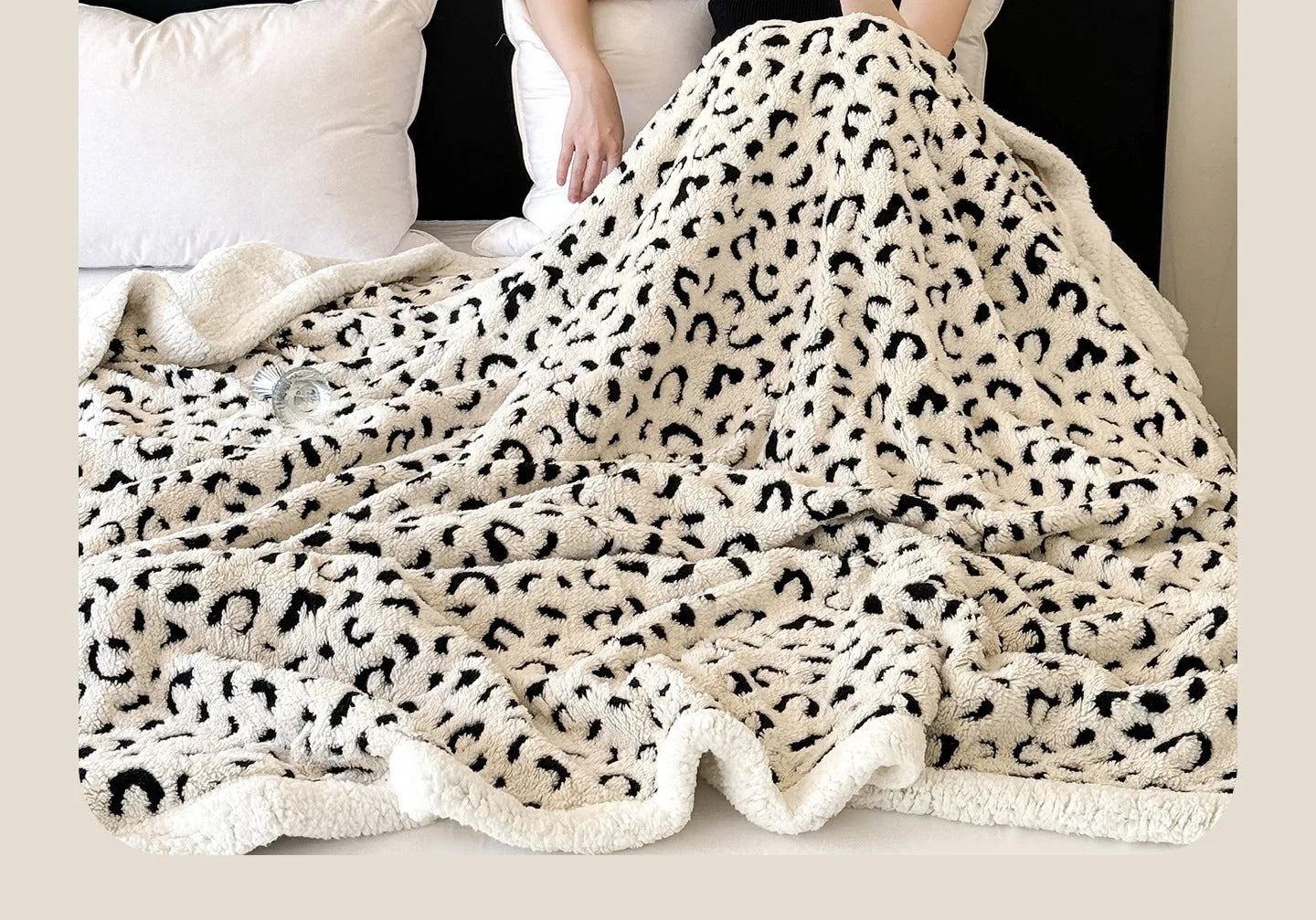 Double-layer taffeta blanket with woven leopard print pattern draped over sofa