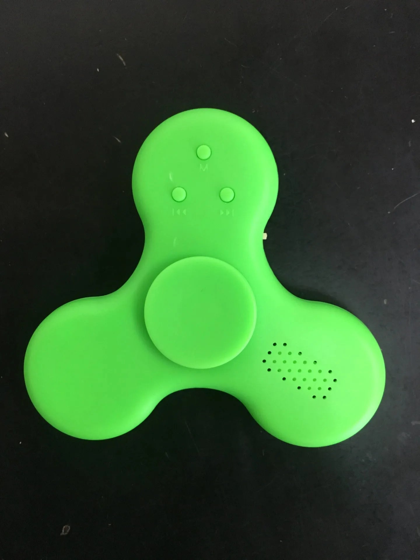 Compact white Bluetooth speaker and MP3 player designed as a fidget spinner toy.