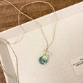 Women's necklace with coloured glaze skirt pendant on cotton linen clavicle chain