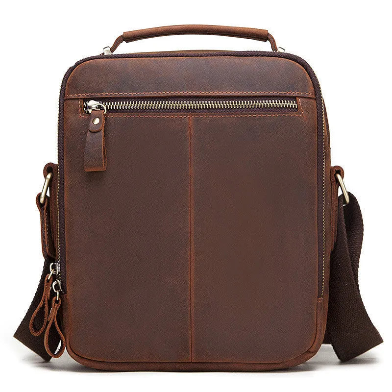 Men's brown genuine leather single-shoulder crossbody bag with visible stitching, shown on a model.