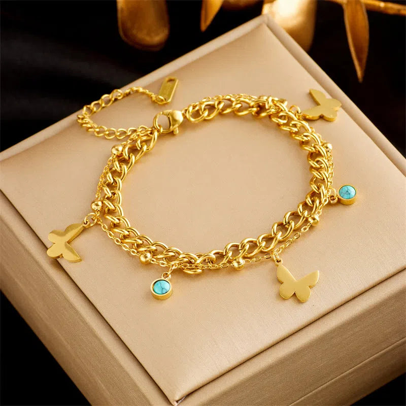 Gold plated titanium steel double layer snake chain bracelet with five-pointed star detail on display
