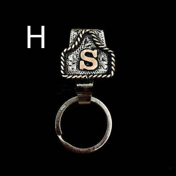 Handmade metal cow tag style key holder shown in one of its 26 colour options, attached to a keyring.