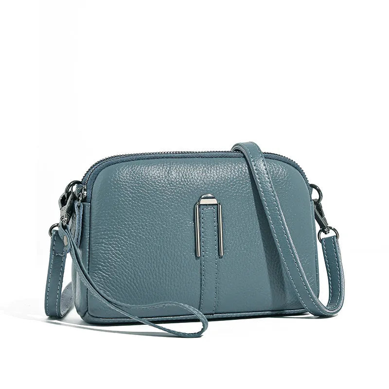 Minimalist crossbody bag in top-grain leather, horizontal square shape, available in five colours including khaki and black