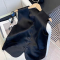 Black satin ladies sleeveless vest with loose fit on a hanger