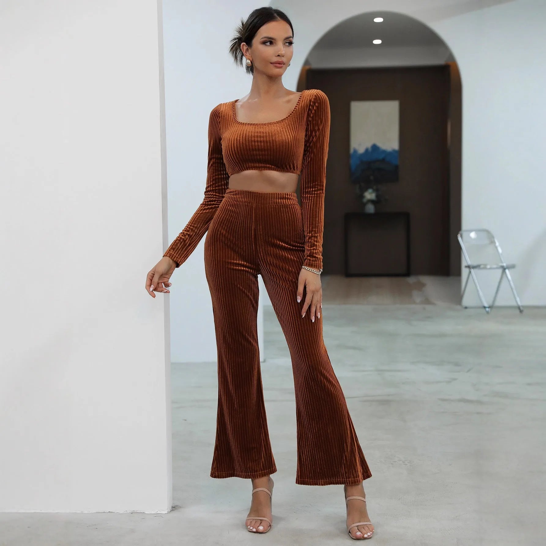 Women's caramel coloured sweater set with long sleeves and matching trousers on hanger