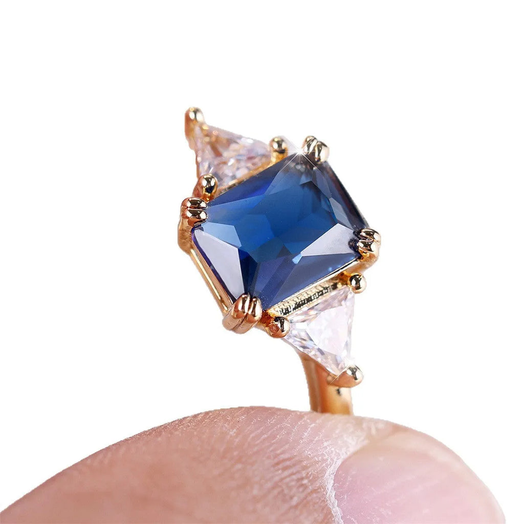 Rectangular gold sapphire blue copper women's ring showing geometric band shape