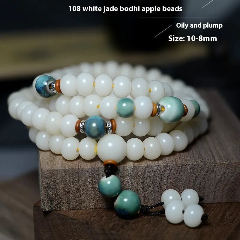 White jade bodhi root bracelet with 108 flat round beads in two sizes on wrist